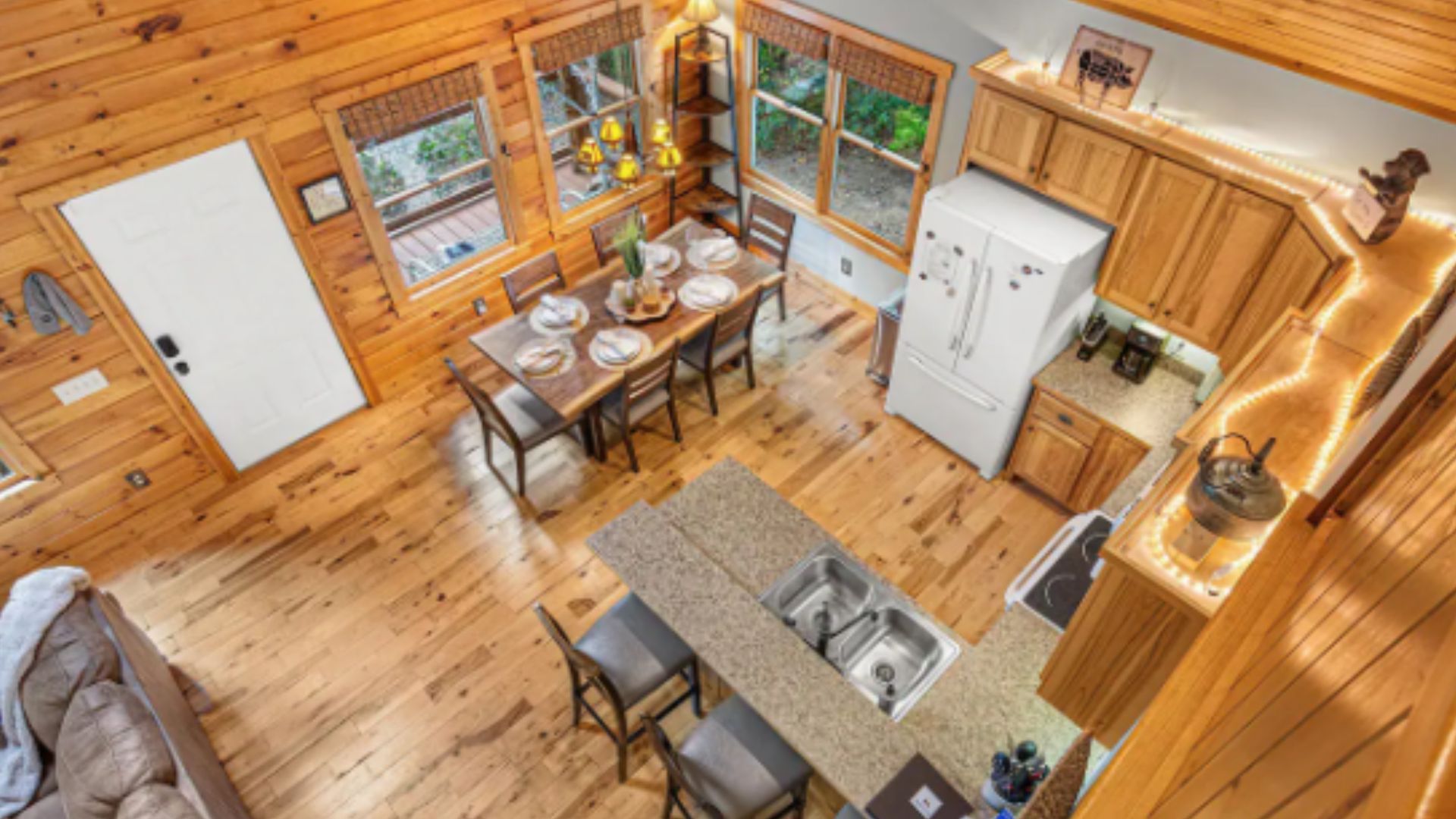 aerial view of the traaditional kitchen with wood cabinets and a dining area next to it