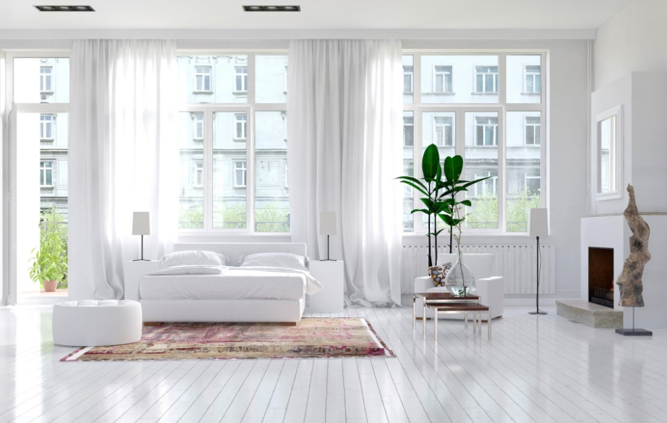 all-white bedroom with white walls, white curtains, white floor, white bed, white chair and big windows