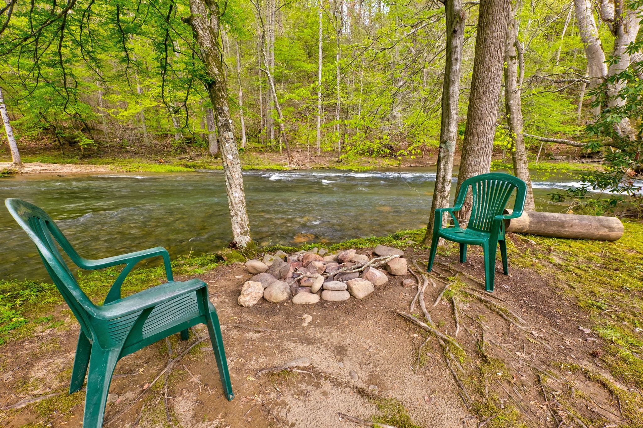 backyard with a creek and two chairs