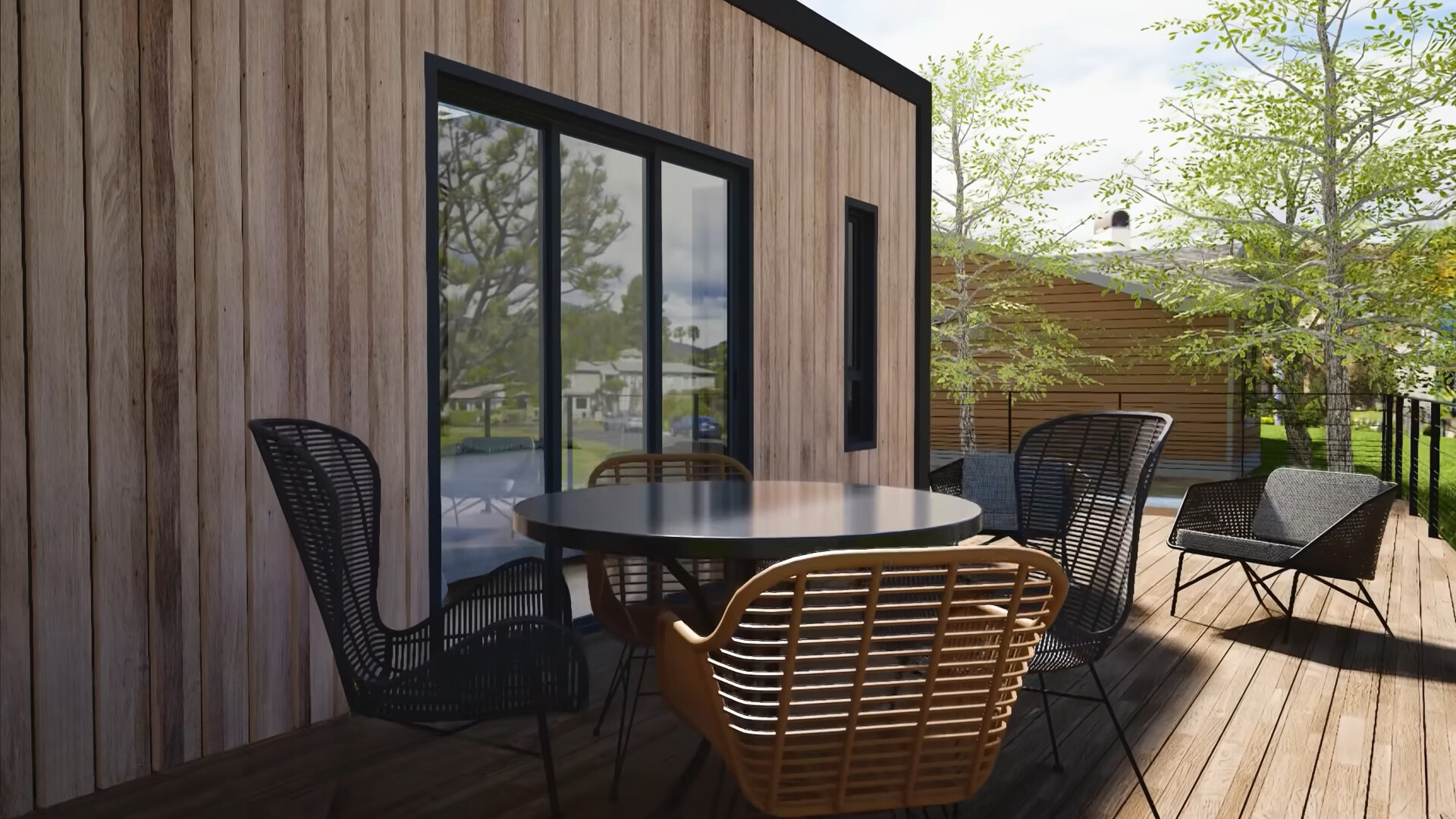 balcony of a container house with chairs around a round black table