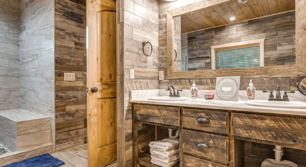 bathroom with wooden cabinets and a big mirror and two sinks