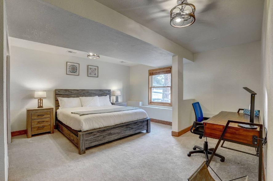 bedroom with a king-sized, office area with a brown desk accompanied by a chair