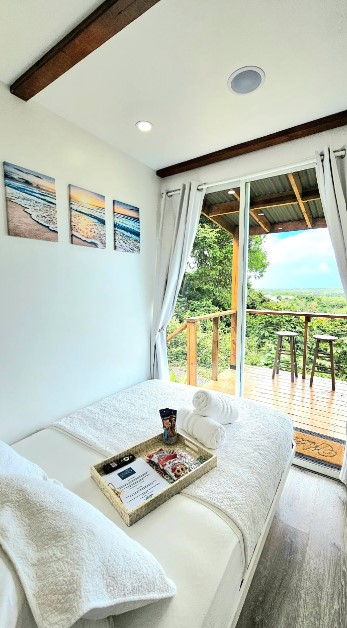 bedroom with a bed and a balcony with glass doors