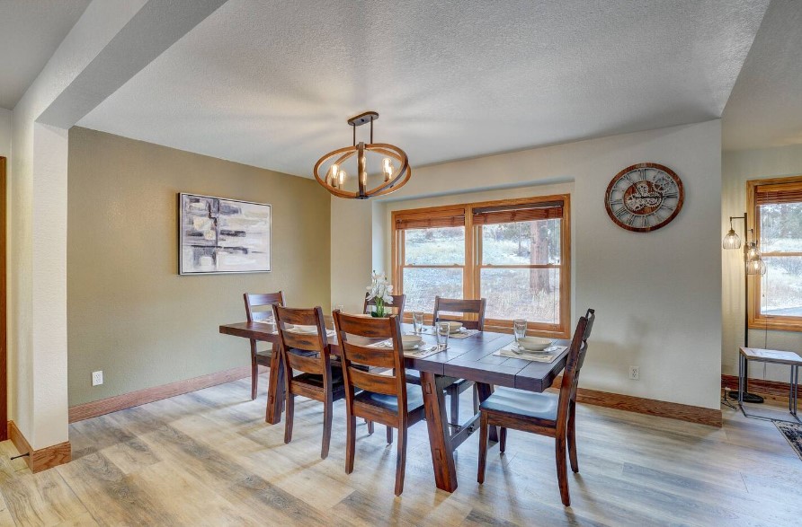 brown dining table and brown chairs of the dining room and big windows