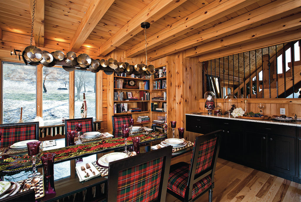 dining room with a decorated brown dining table and wooden walls and wooden beams