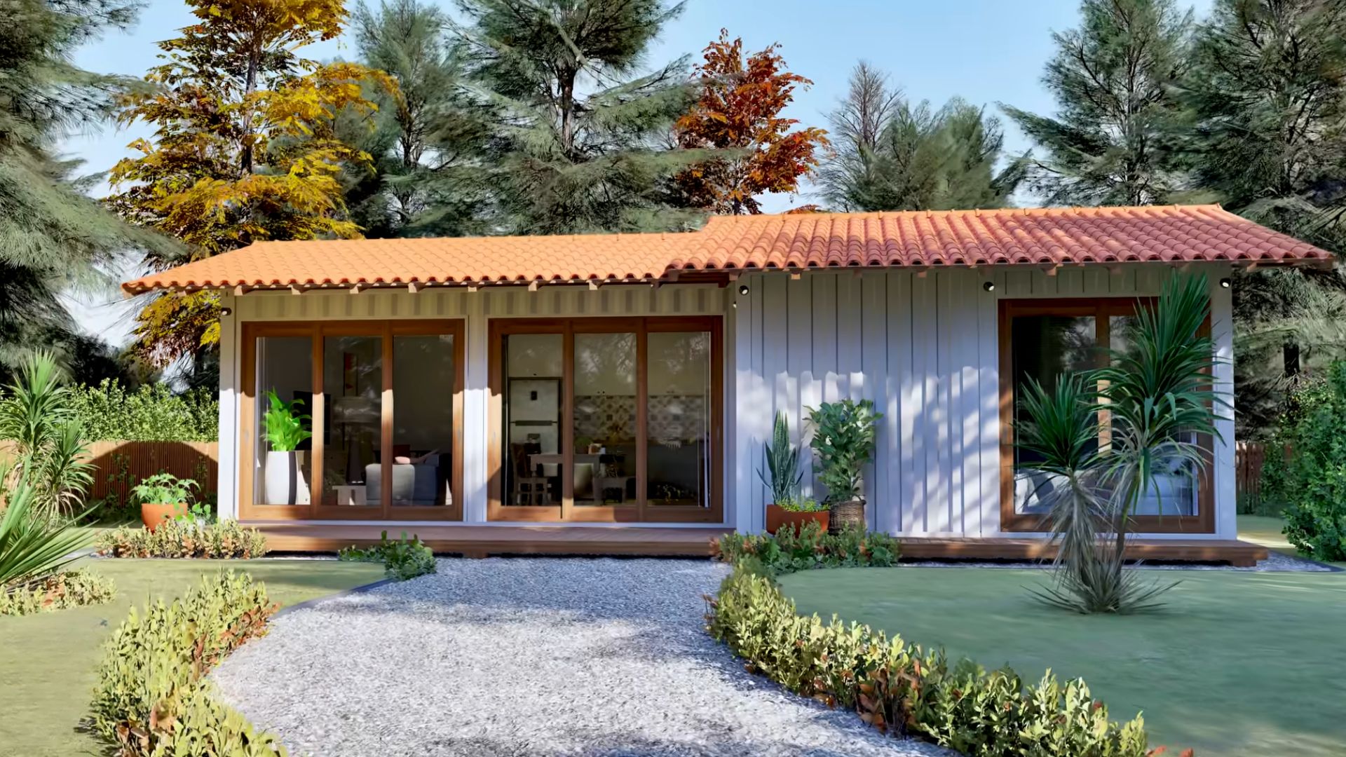 exterior of the family container home with picturesque windows, lots of plants and flowers in the front of the house, woods int he back, white facade with a reddish roof