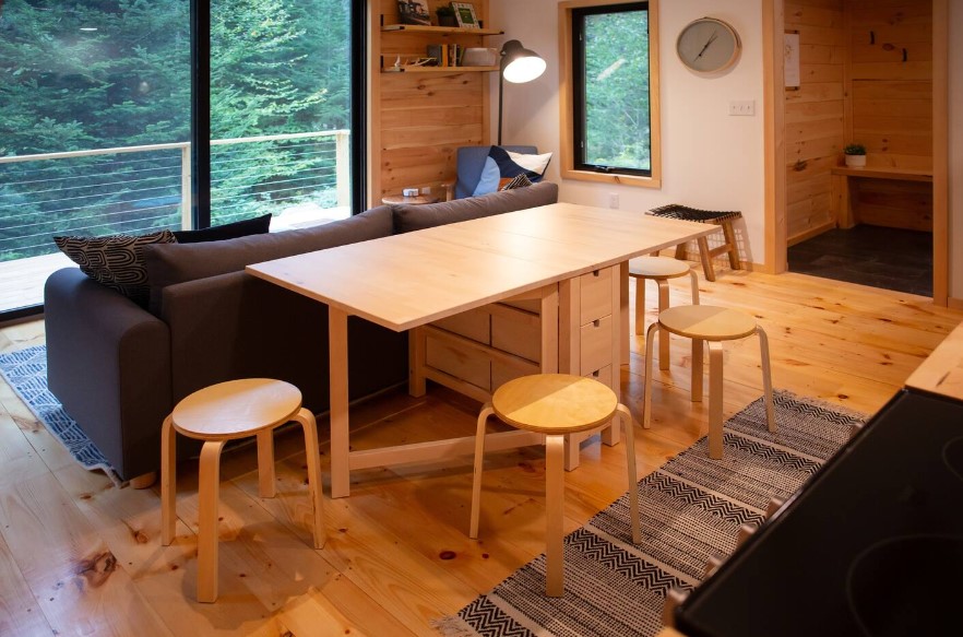 foldable wooden dining table and round brown stools