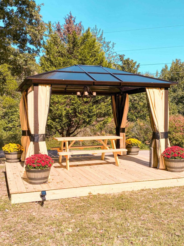 gazebo with a light brown dining table