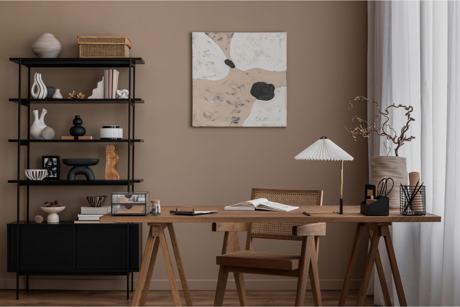 Home office with a wooden desk and chair and a black shelf