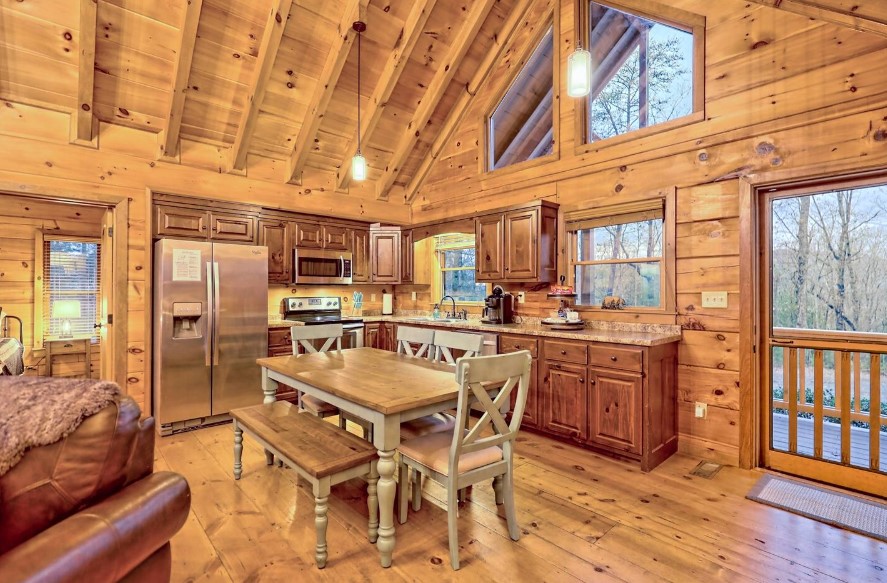 kitchen and dining room with brown cabinets, brown dining table and light green chairs