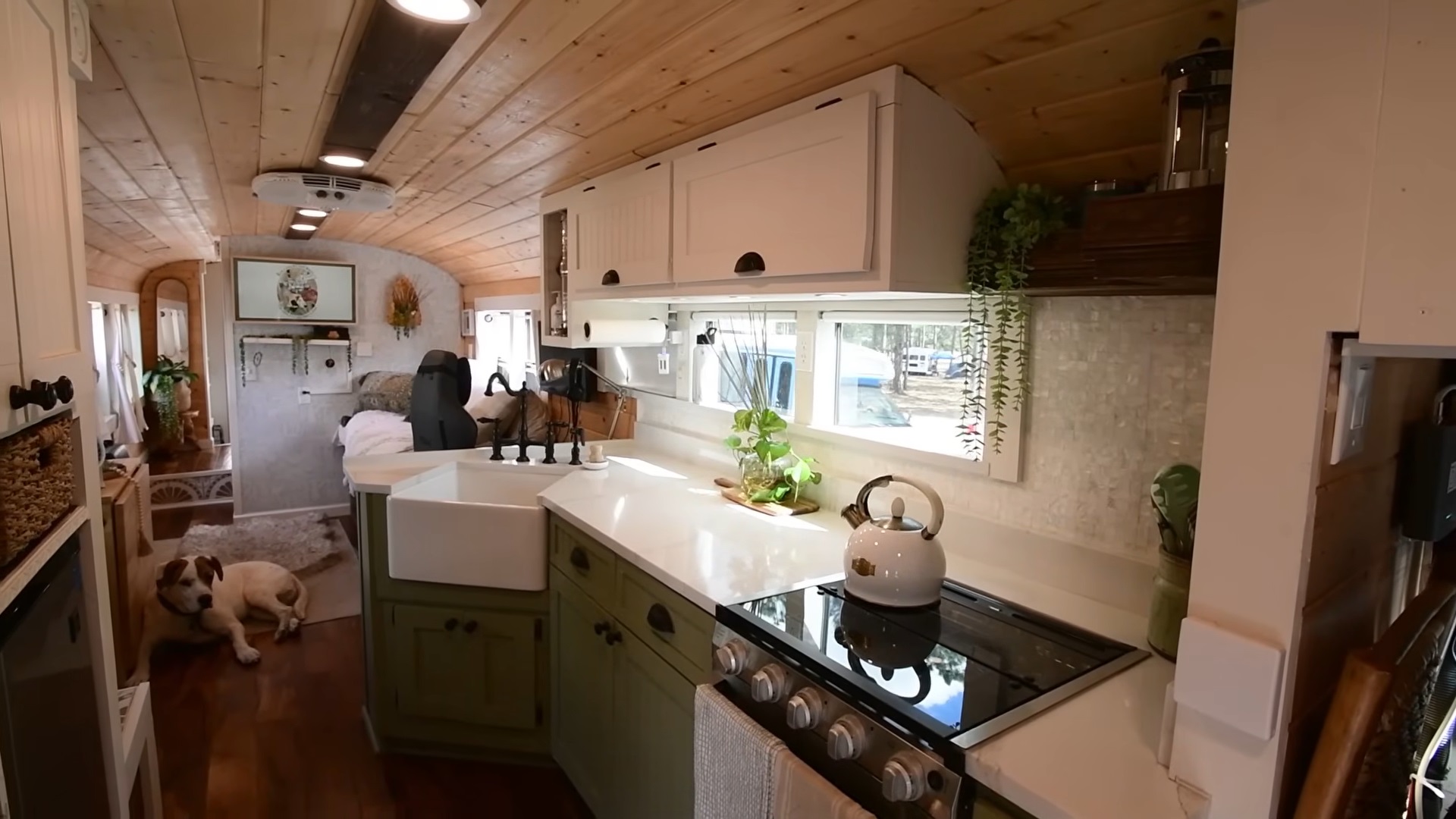 kitchen with white and green cabinets, wooden ceiling, semi l-shaped white countertop