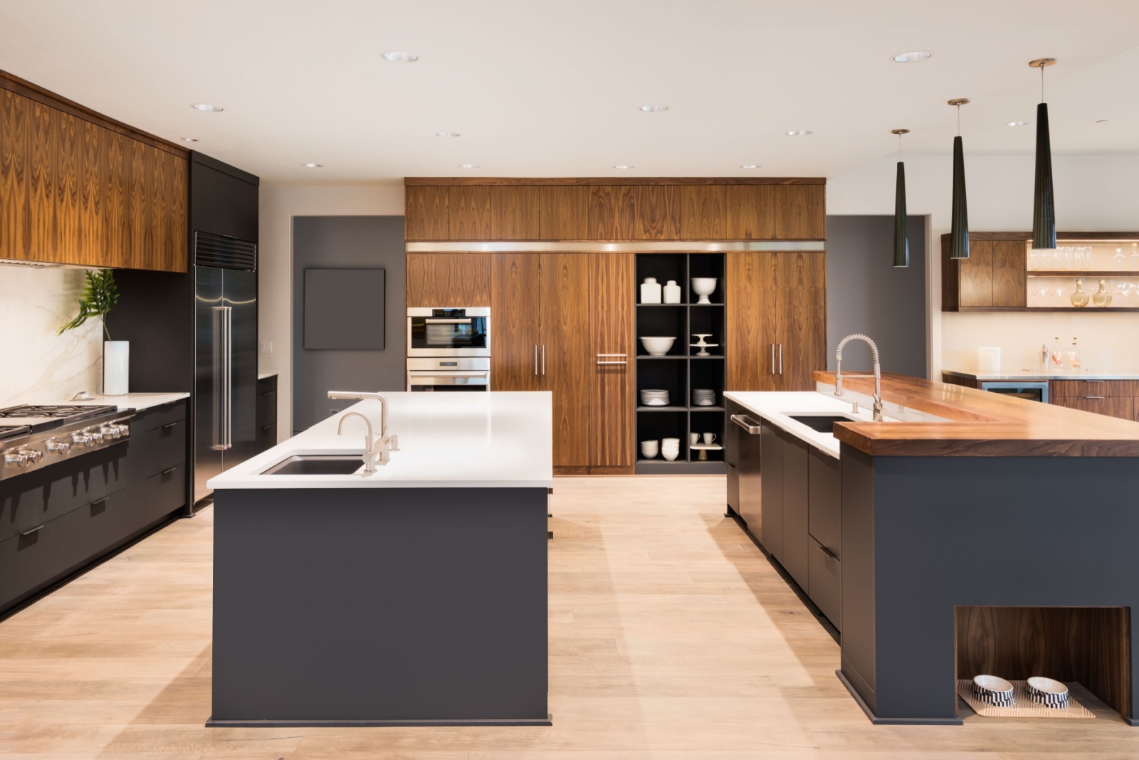 kitchen with two islands, brown cabinets and a white countertop under the cabinets