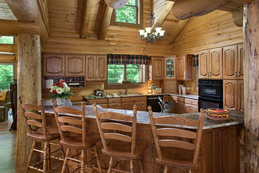 kitchen with brown cabinets, island, brown chairs at the island