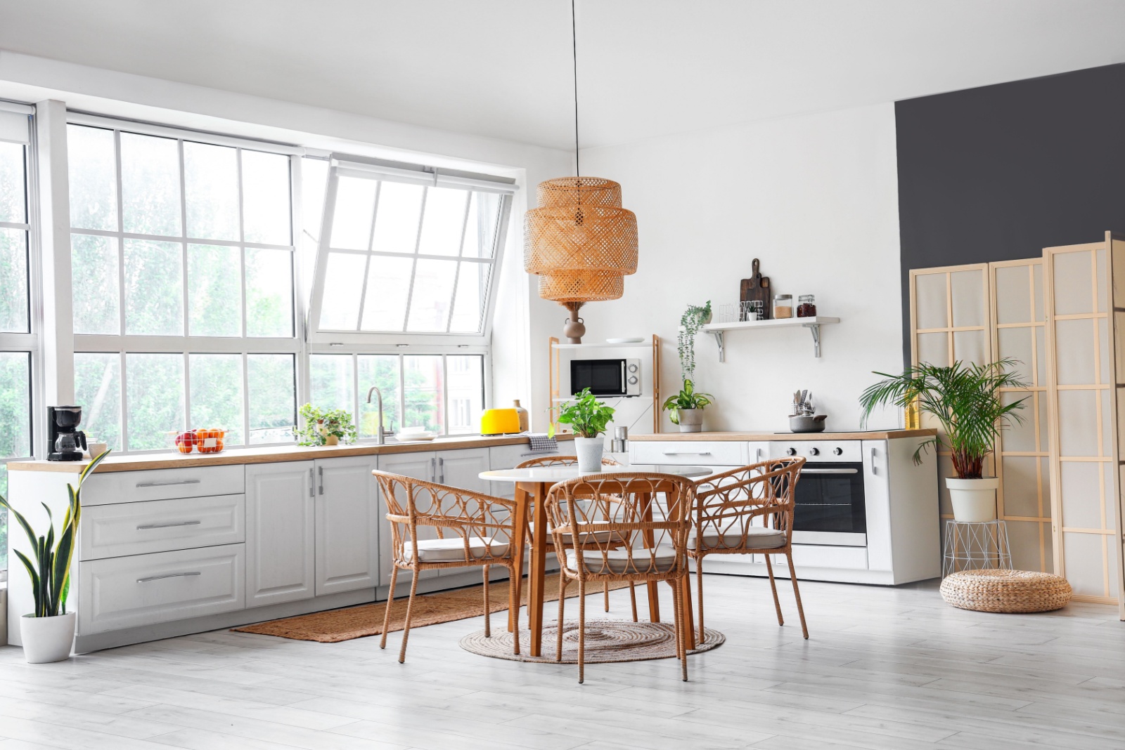 kitchen with huge windows, l-shaped countertop and white cabinets