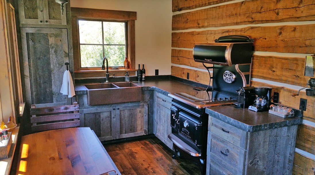 kitchen with wooden cabinets, wooden table and a window above the sink