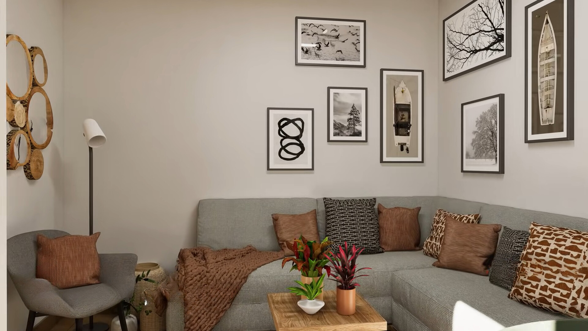 living room with a gray l-shaped couch and a sofa, mini brown table, framed photos of the wall in black and white and sepia and wooden mirrors