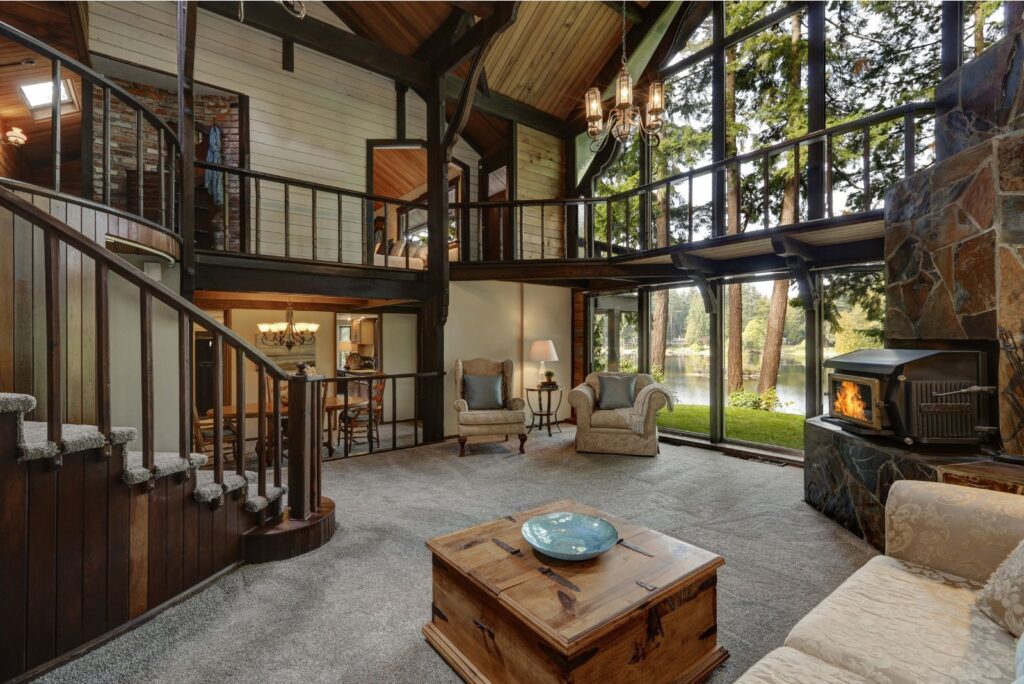 Farmhouse living room with gallery balcony and a glass wall