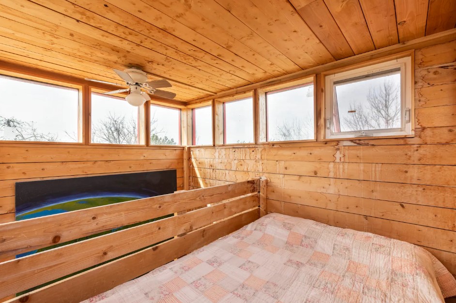 loft bedroom with windows around