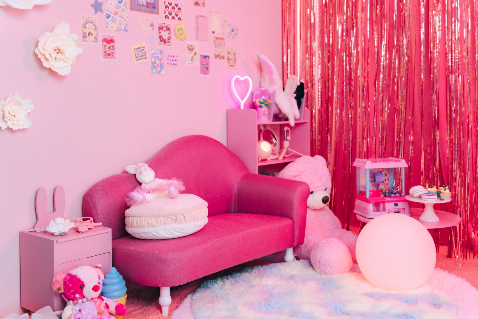 pink bedroom with a mini pink couch, tiny pink cabinet, small pink table, pink cabinet, pink decor