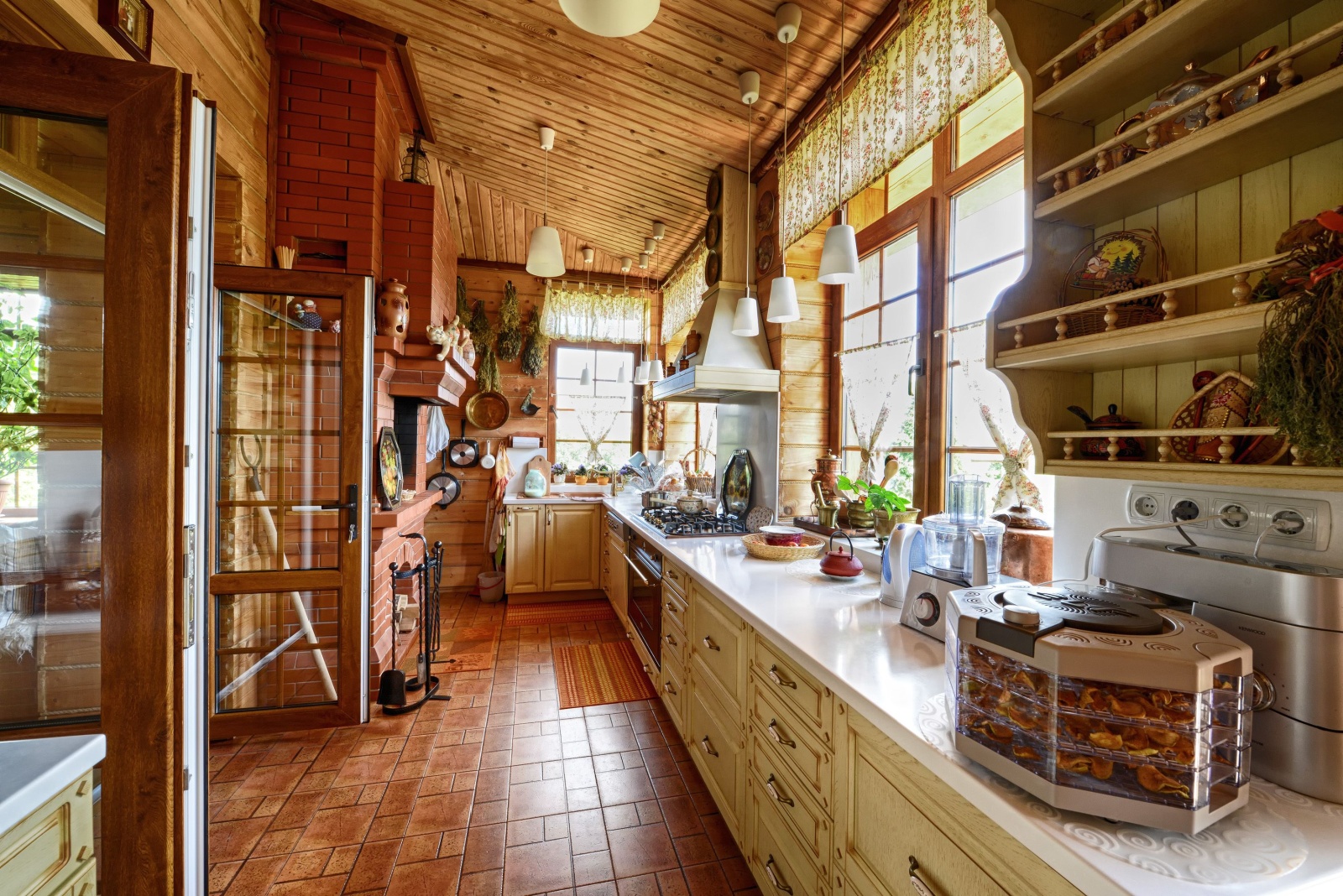 rustic kitchen with wooden walls, light wooden cabinets, plenty of shelves