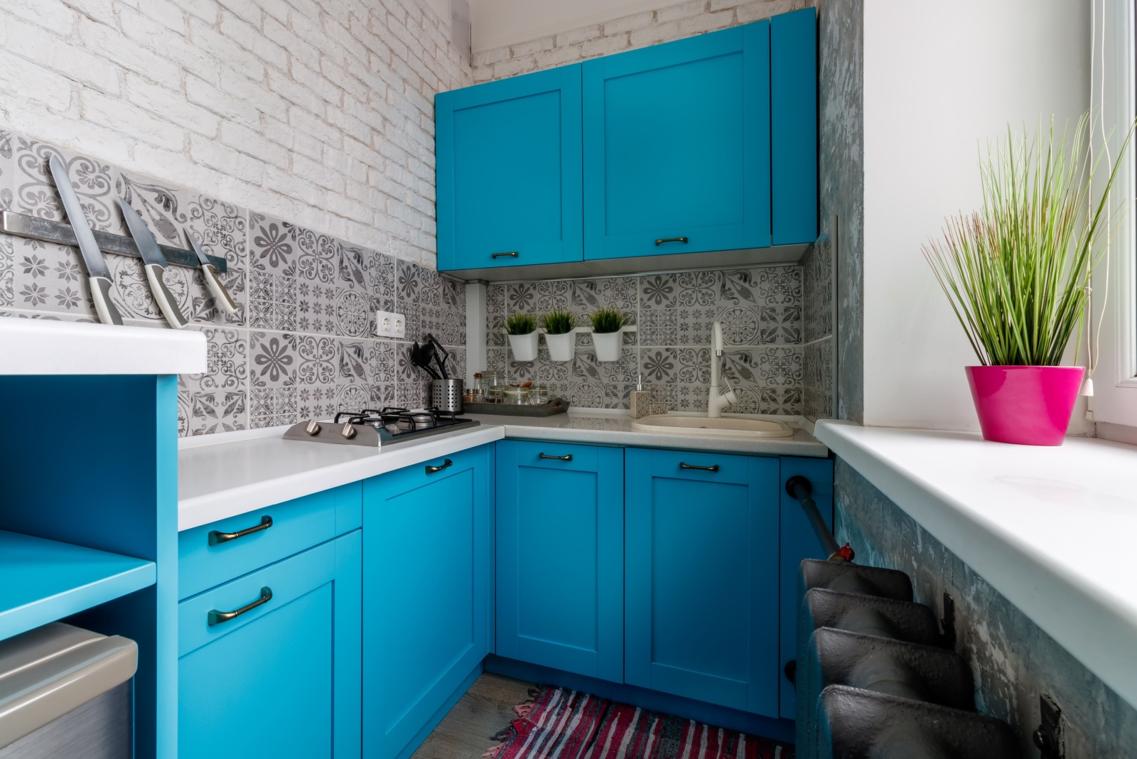 kitchen with vivid blue cabinets and a patterned wall