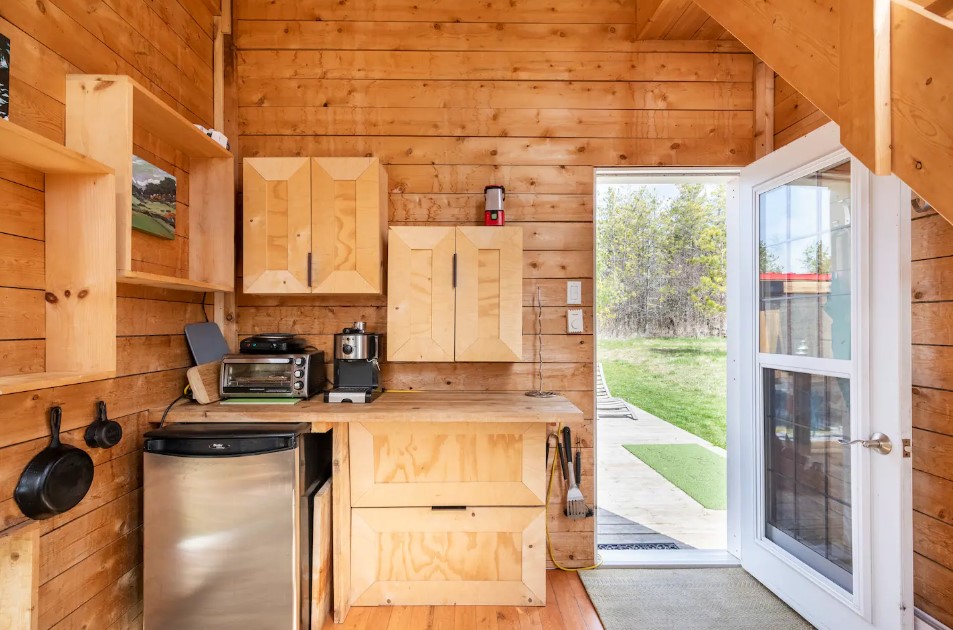 kitchen with wooden cabinets, wooden walls, wooden shelves, wooden countertops