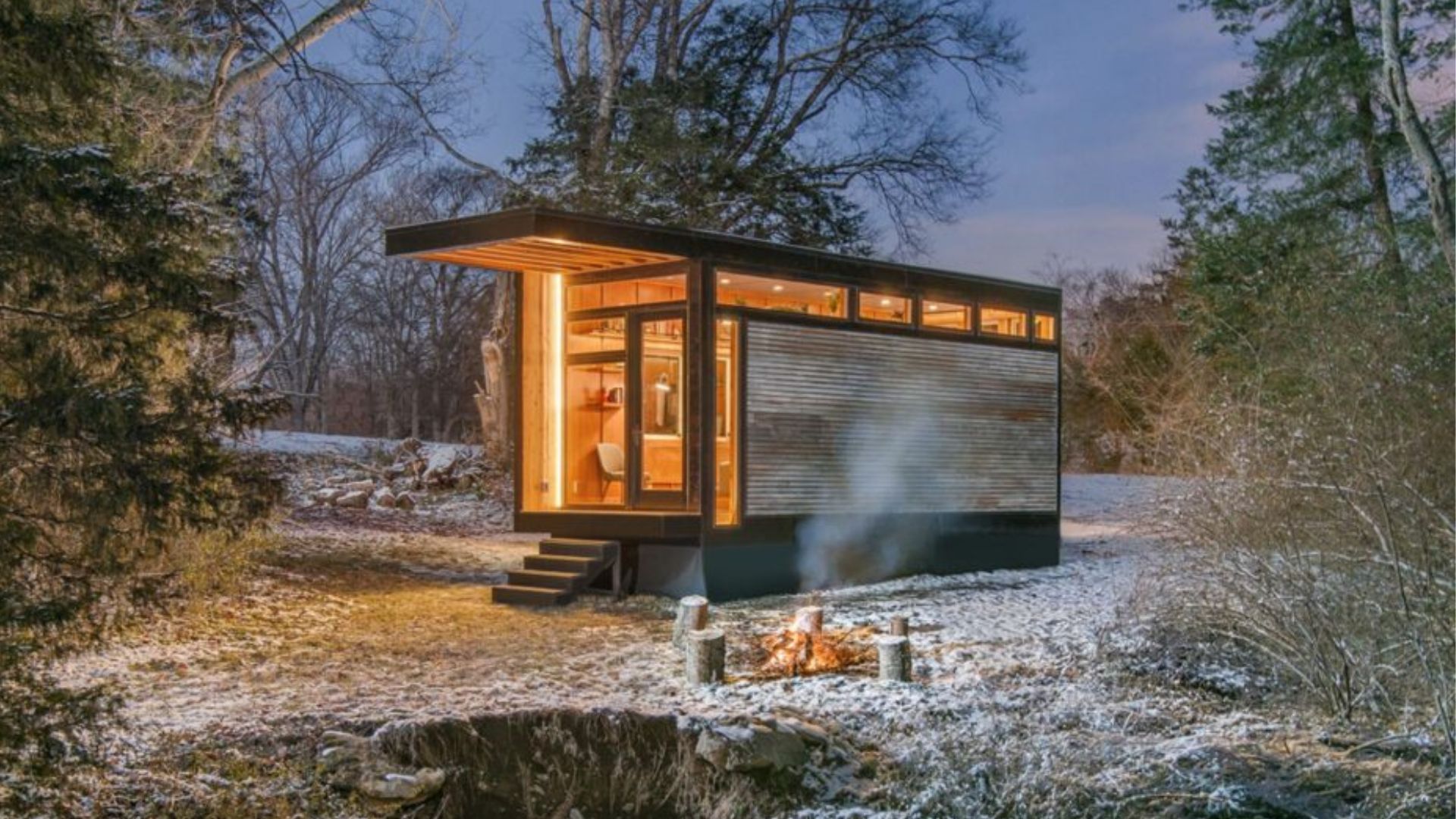 exterior of a tiny home with warm lightning in the woods