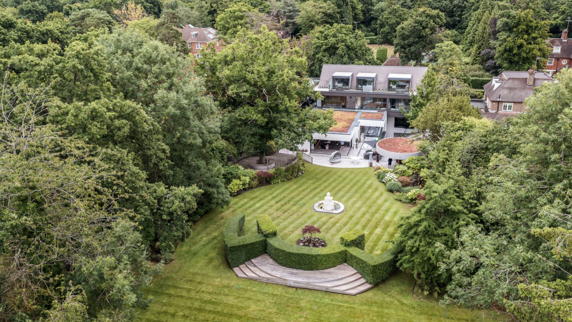 Huge home with exposed red brick and its backyard