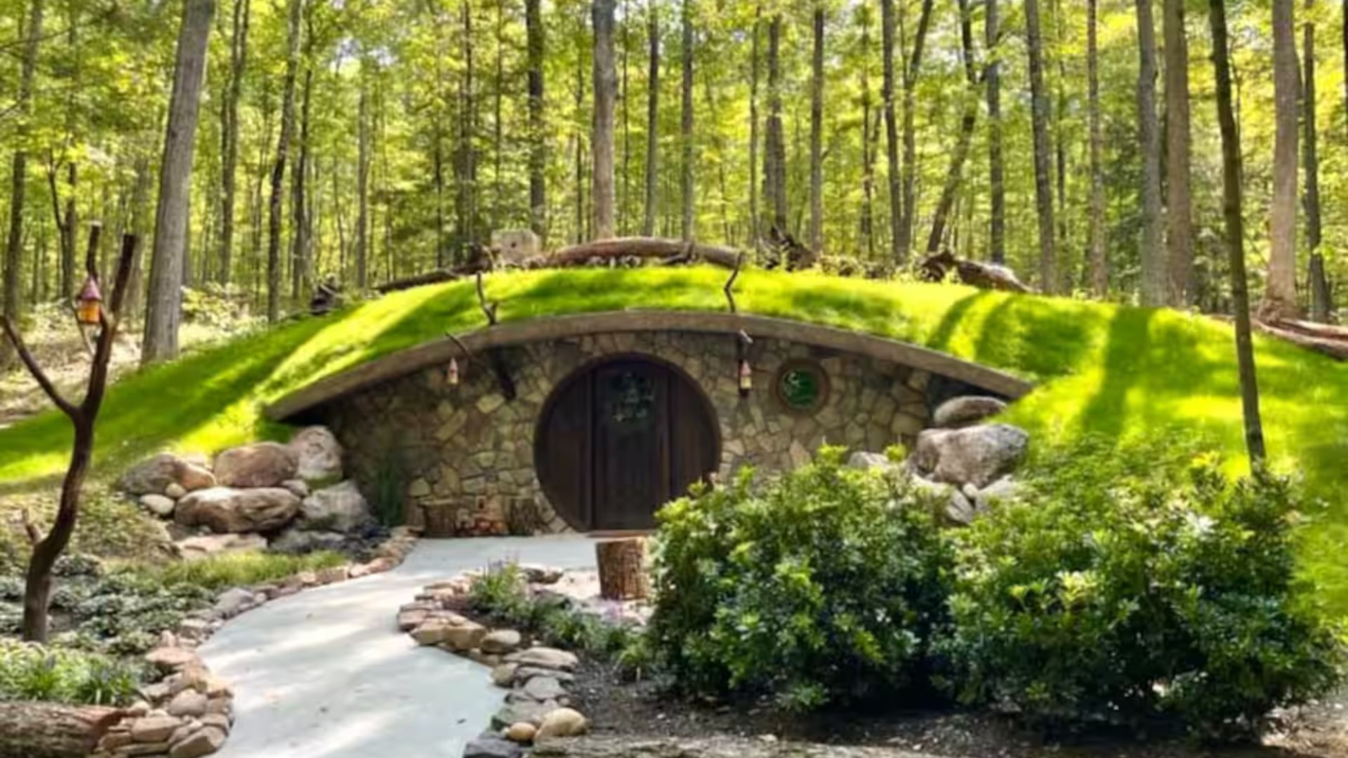 hobbiton house with round front door and covered in grass