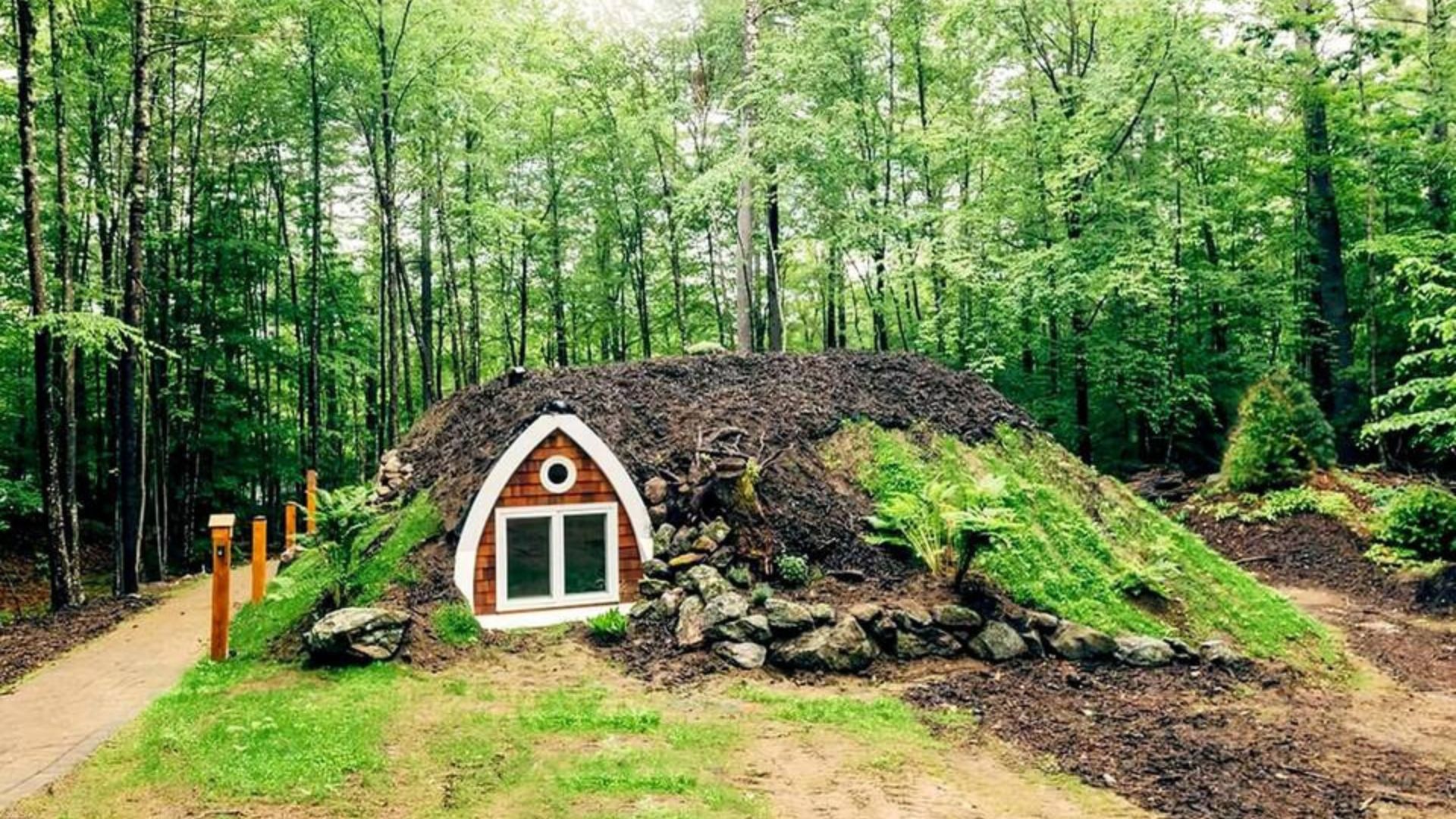 outside a hobbit burrow covered with grass