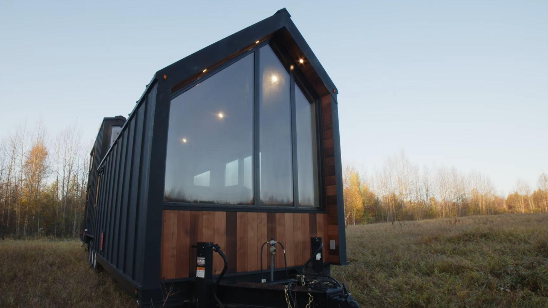 Black tiny house with glass doors