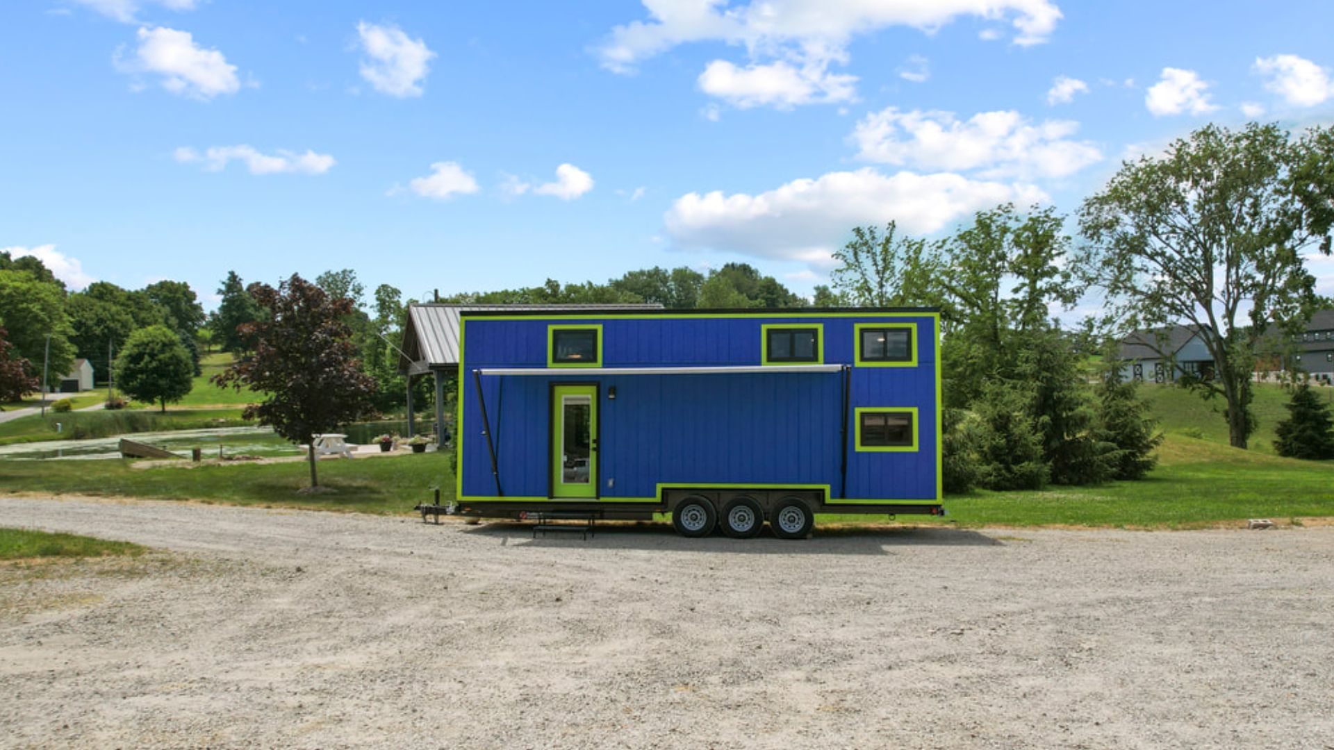 exterior of a blue tiny home on wheels