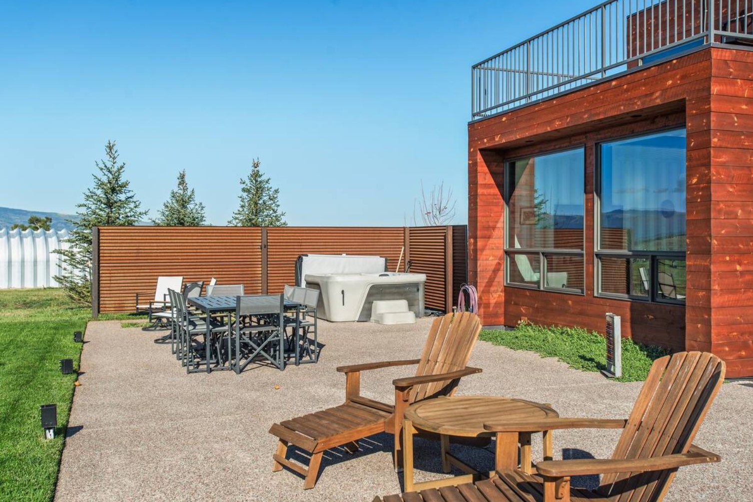 Backyard of a farmhouse container with a hot tub