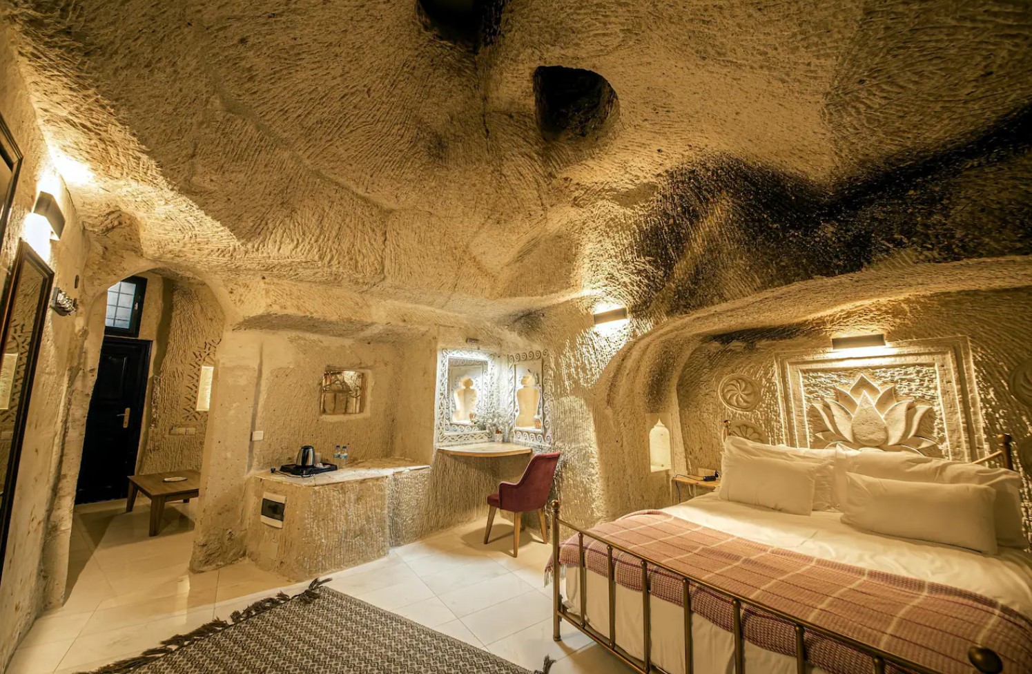 Bedroom in a cave home with a carved lotus above the bed