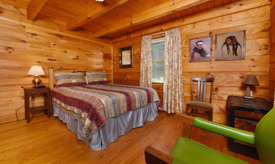 Bedroom with colorful bedding, decorations and art on the wall