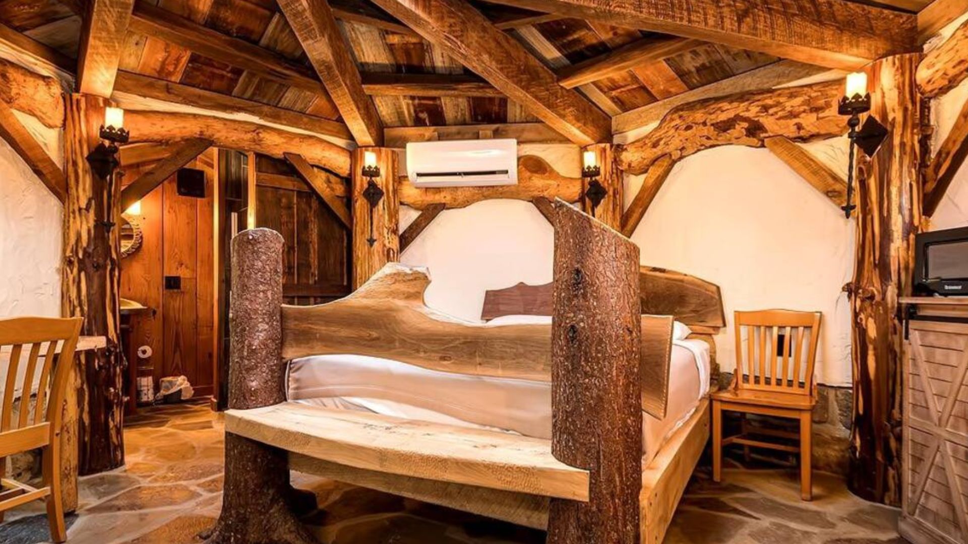 rustic bedroom in farmington hobbit house with a cool wooden bed