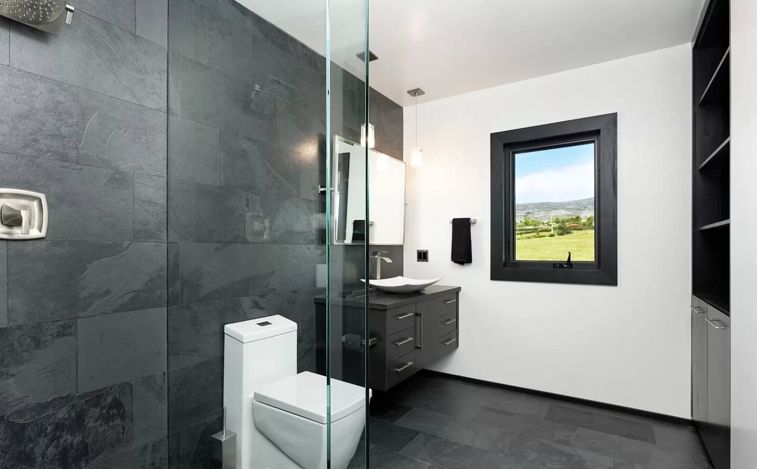 Black and white bathroom with tiles and a window