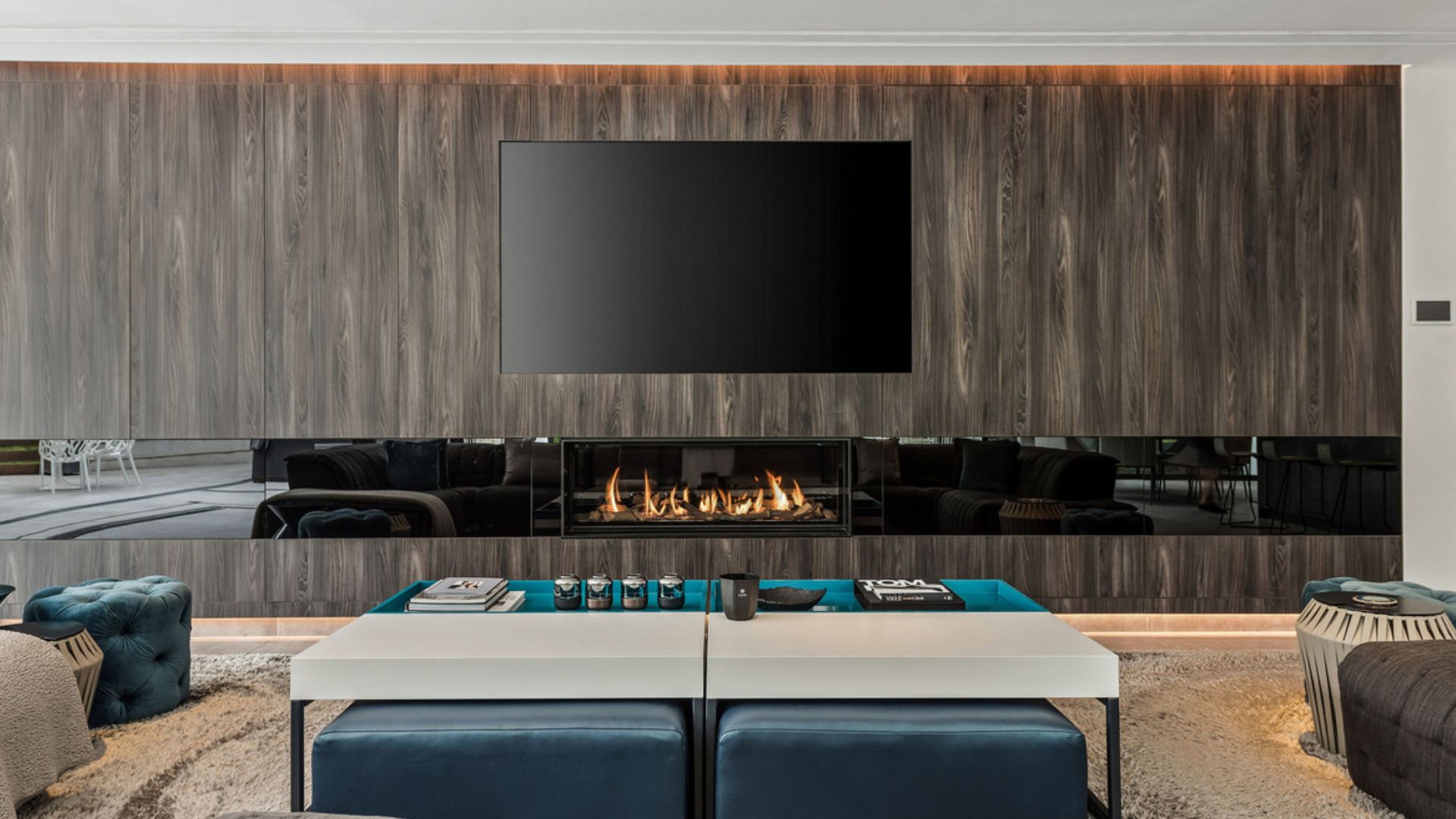 gorgeous, massive, and impressive wall with a TV and a fireplace under