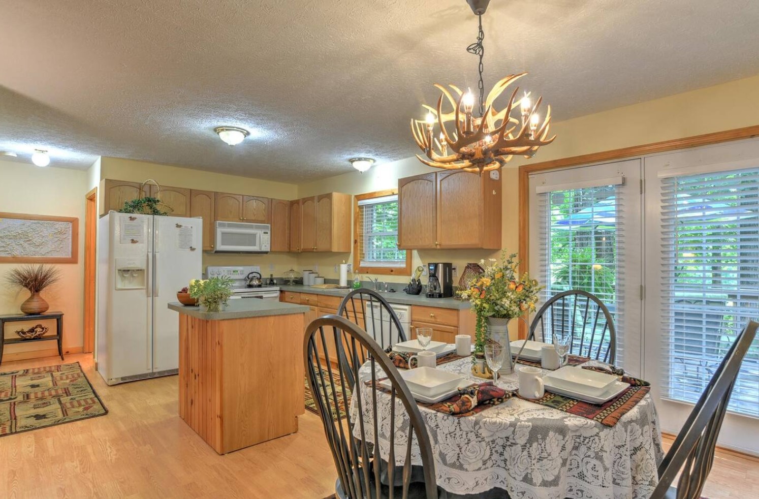 Cozy cabin kitchen with a white fridge and a dining table 