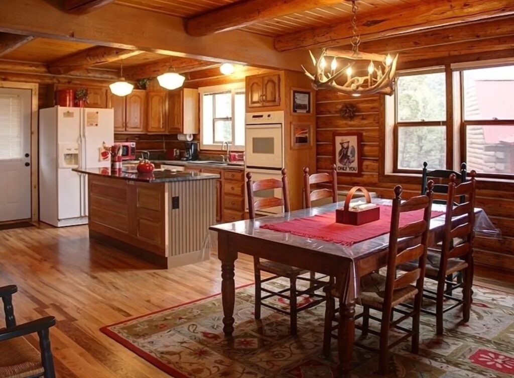 Cabin kitchen with a white fridge and wooden cabinets