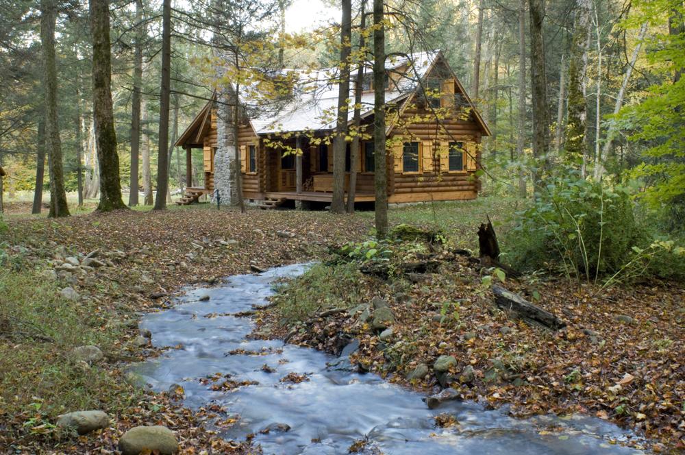 Cabin with a creek in the woods