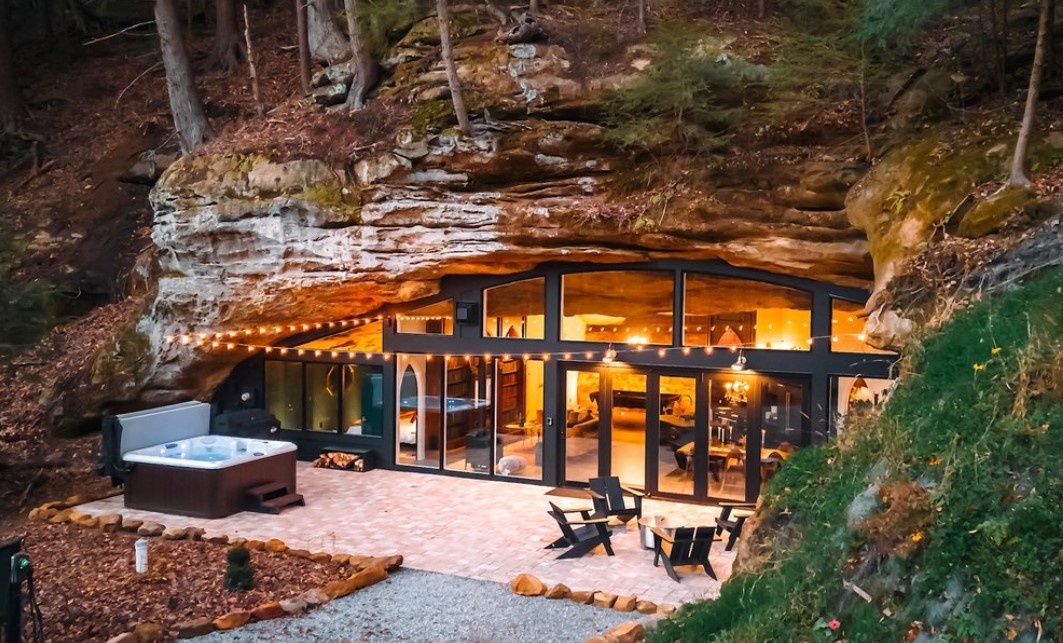 Cave home with a glass wall and hot tub