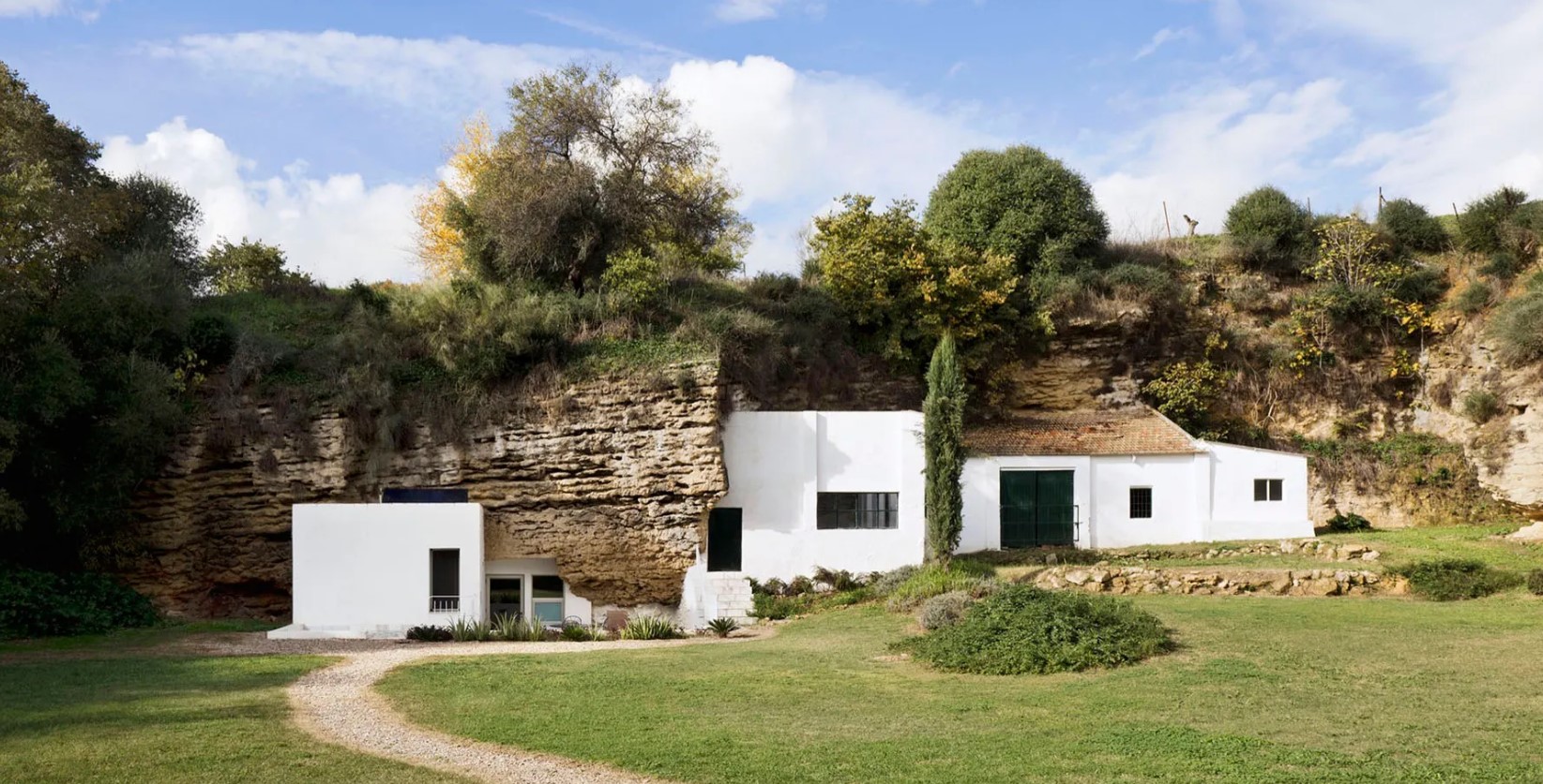 Modern cave home with white exterior walls