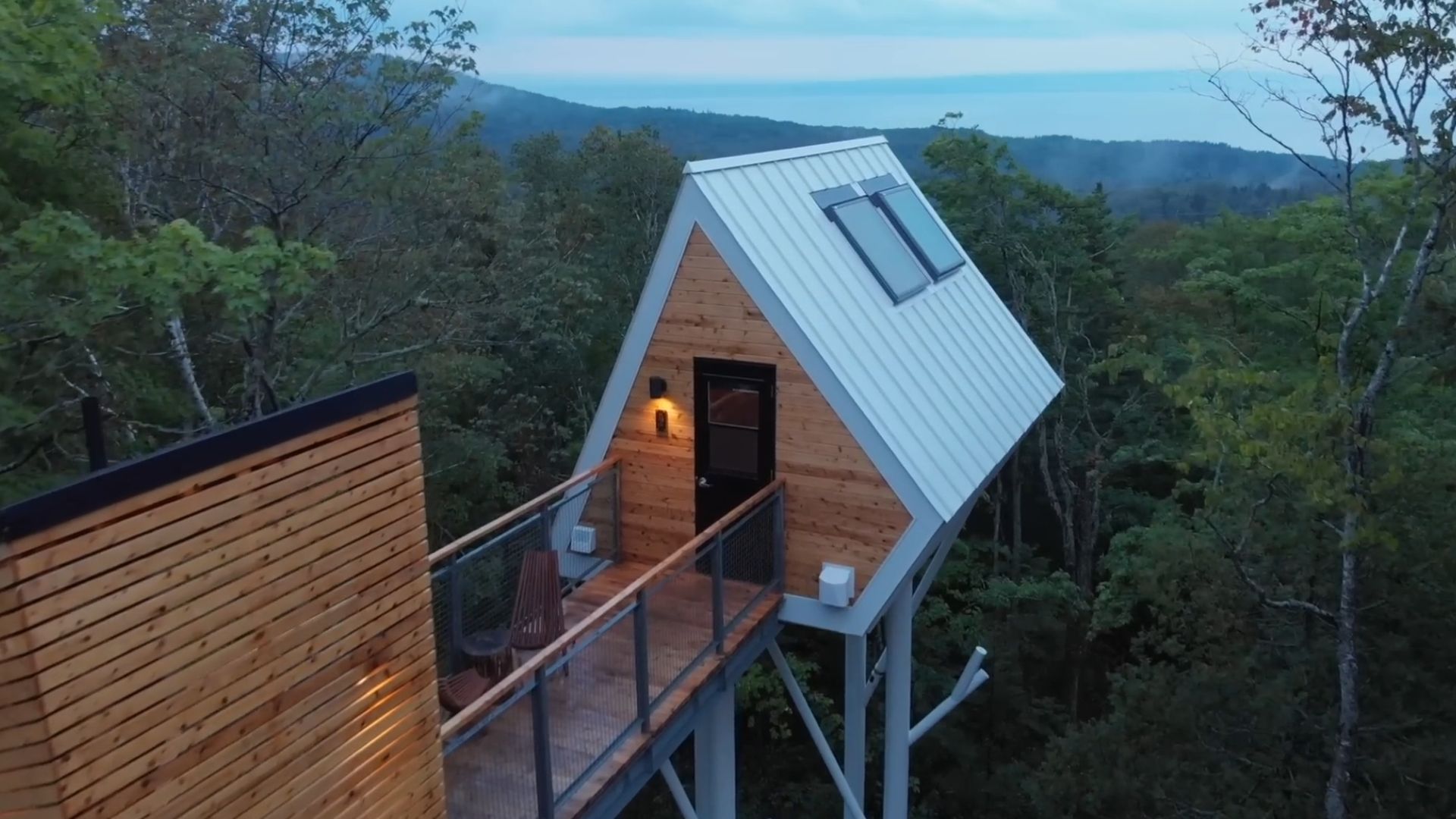 White diamond shaped cabin in forest