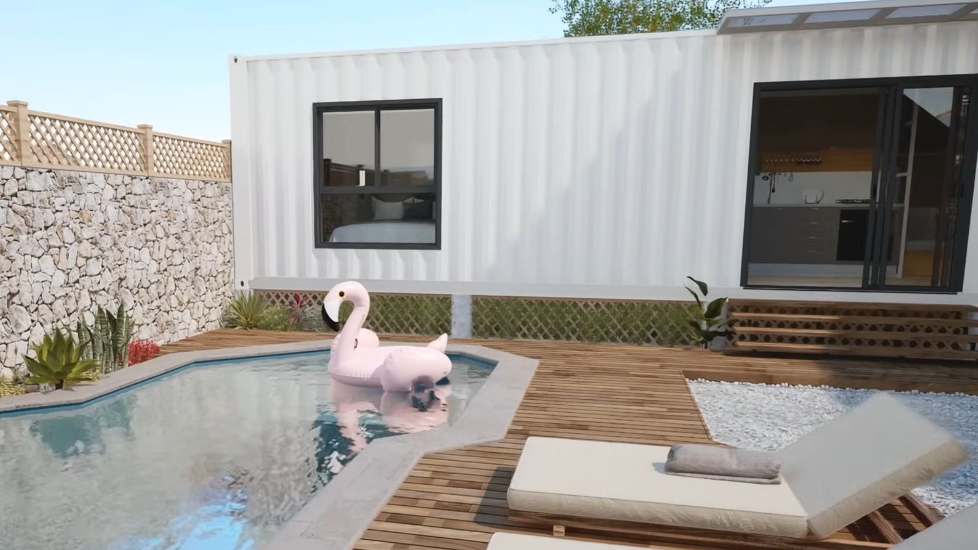 exterior of the container house with an irregular-shape pool, a flamingo floatie on it, two lounges, and a lounge area in the back right