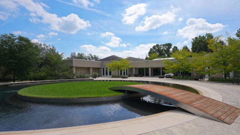 exterior of michael jordan's mansion with a small pond