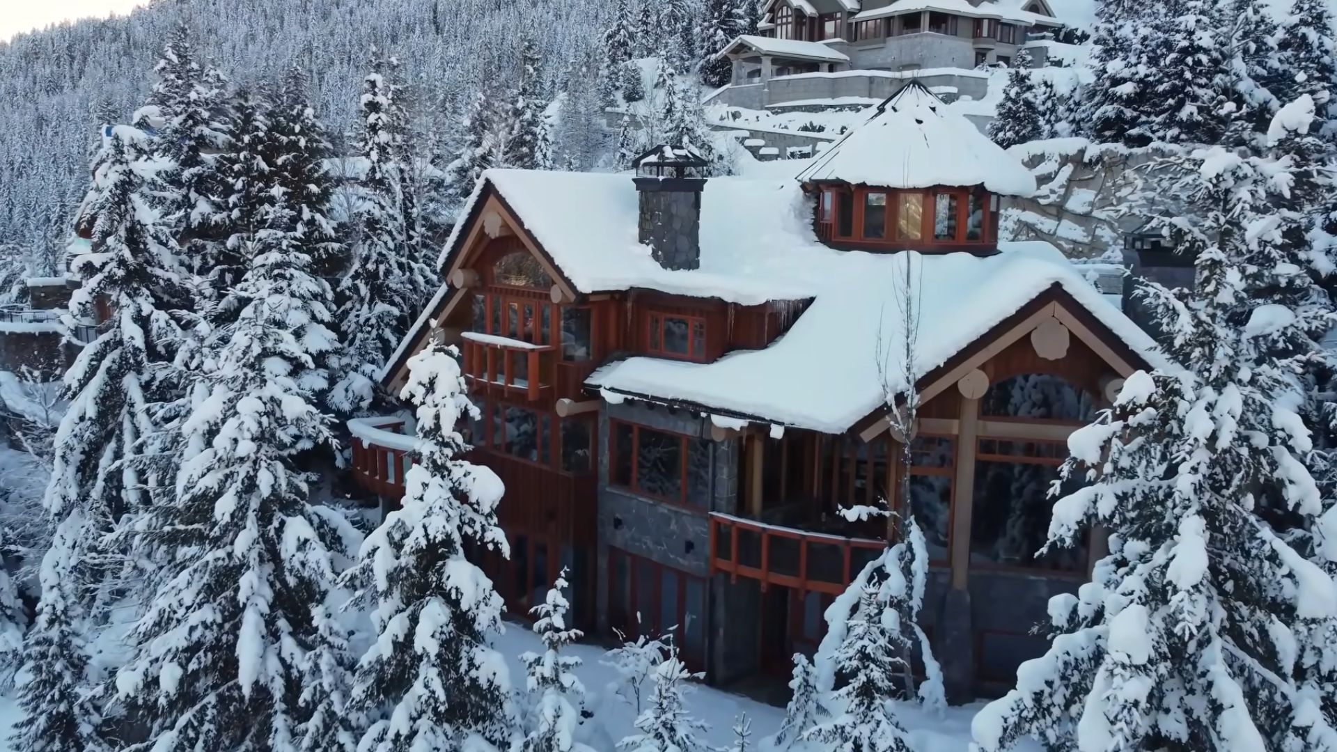 exterior of a cabin covered in snow