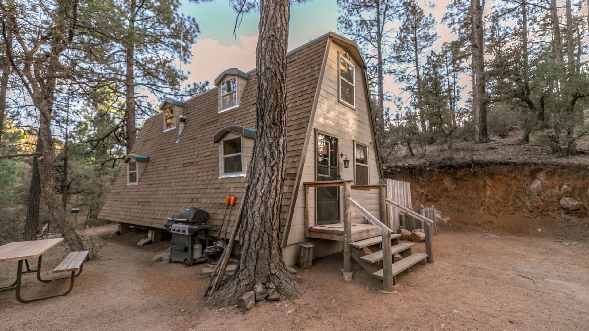 exterior of an a-frame cabin in the woods