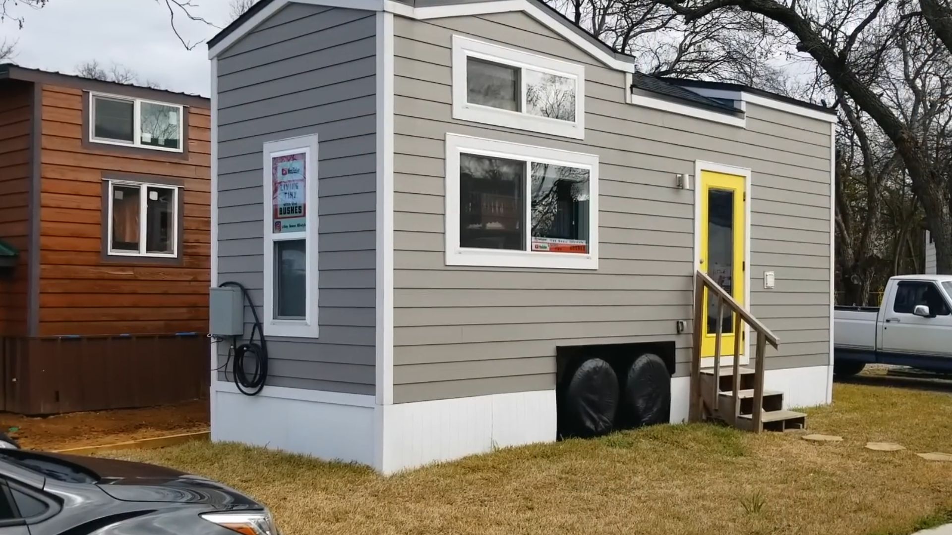 exterior of a tiny house with grey and yellow walls