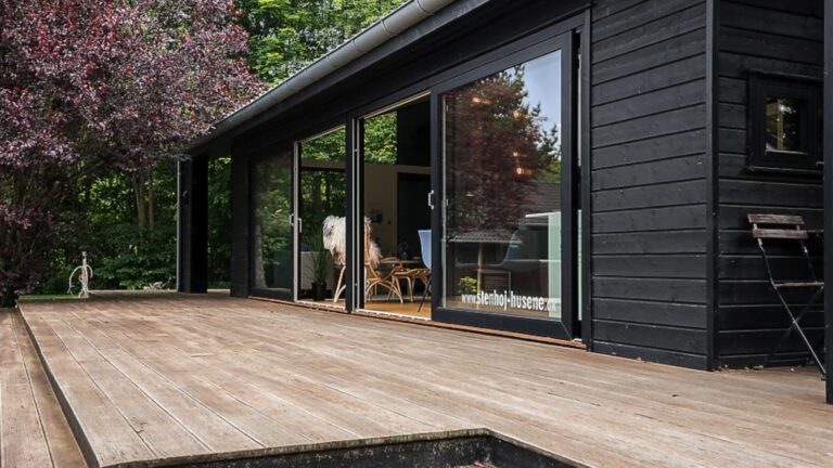 exterior of a modern cottage house with black walls